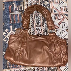 Vintage Coach bag with unique rose gold as clasp. light weight & smooth leather